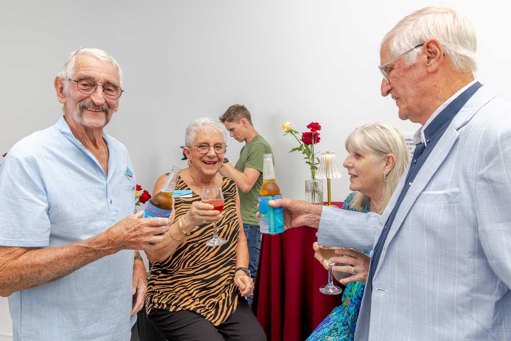 Older friends toasting drinks at social gathering